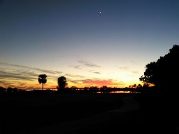 Silhouette trees against sky during sunset