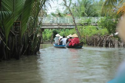 People sitting on boat in river