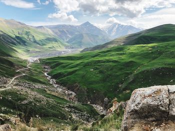 Scenic view of green mountains against sky