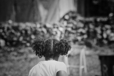 Rear view of girl with pigtails playing at park