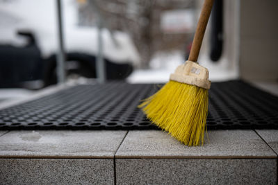 Floor brush on the doormat in front of the house