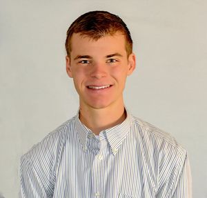 Portrait of smiling man standing against white background