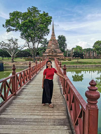 Full length of thai woman standing at temple