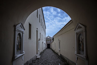 Empty alley amidst buildings in city