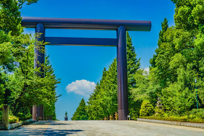 Road by trees against sky