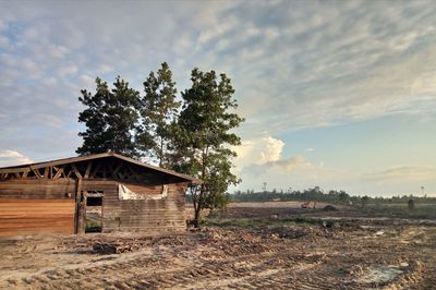 Abandoned building on field against sky