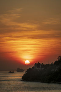 Scenic view of sea against romantic sky at sunset