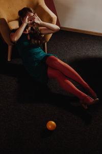 High angle view of woman lying on floor at home