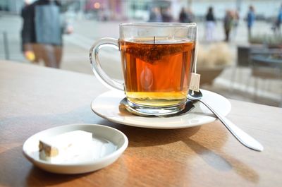 Close-up of tea with sweet food on wooden table