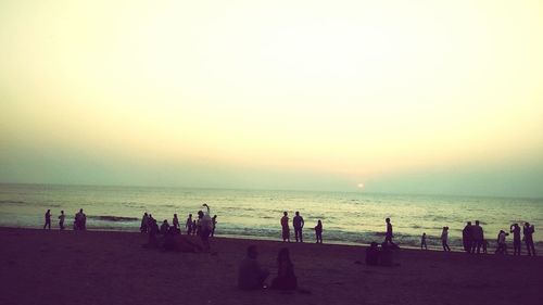 People on beach at sunset