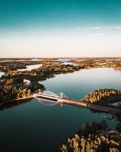 High angle view of sea by city against sky