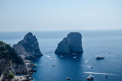 Scenic view of rocks in sea against sky