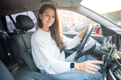 Portrait of woman sitting in car