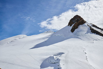 Low angle view of snowcapped mountain against sky