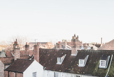 Houses in city against clear sky