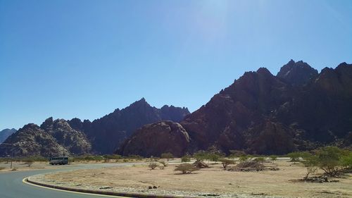 Scenic view of mountains against clear blue sky