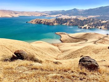 Scenic view of sea and mountains against sky