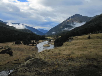 Scenic view of mountains against cloudy sky