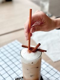 Close-up of hand holding coffee cup