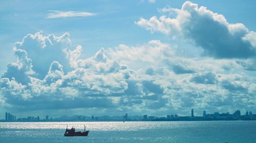 Boats sailing in sea against sky