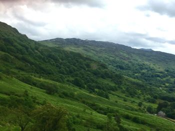 Scenic view of green landscape against sky