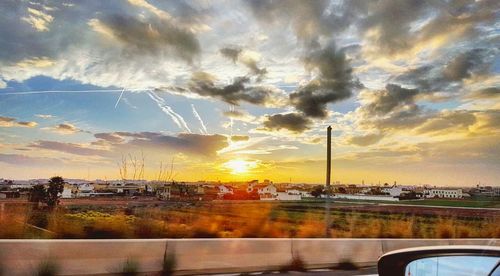 Cars on road at sunset