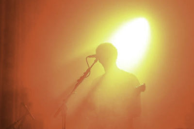 Silhouette of man playing guitar