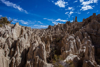 Low angle view of rock formations against sky