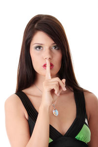 Portrait of beautiful young woman against white background