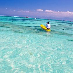 Man in boat on sea against sky