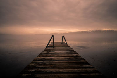 Jetty on the water in the fog