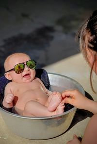 Baby boy in bathtub on sunny day