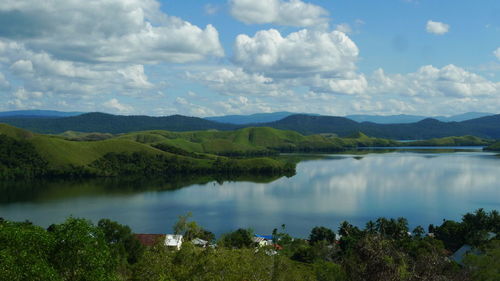 Scenic view of lake and mountains against sky