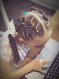 High angle view of girl using laptop at home