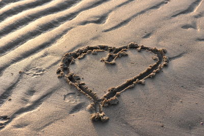 High angle view of heart shape on sand