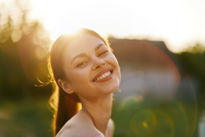 Portrait of young woman with arms crossed standing outdoors