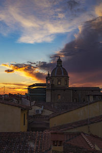 Buildings in city during sunset