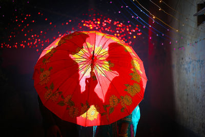 Low angle view of illuminated lanterns hanging at night