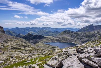 Scenic view of lake at rocky mountains against sky