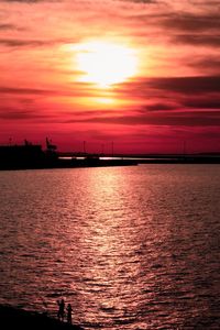 Scenic view of sea against orange sky