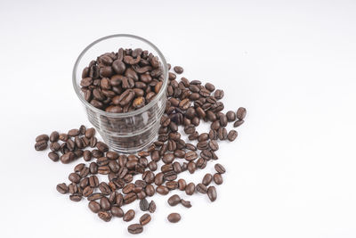 Close-up of roasted coffee beans against white background