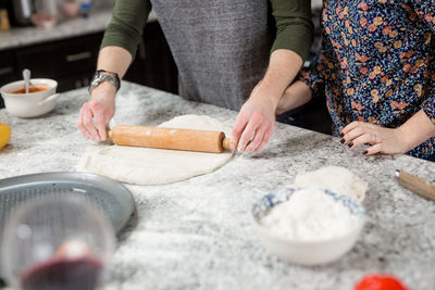 Midsection of women preparing food in kitchen