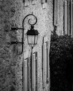 Low angle view of street light against building