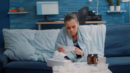 Young woman sitting in bed