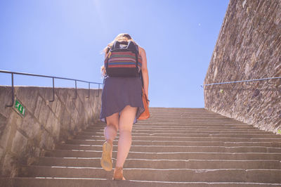 Low angle view of woman walking on steps