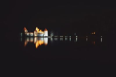 Illuminated built structure against clear sky at night