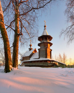 Church amidst trees against blue sky