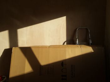 Close-up of cardboard box against wall