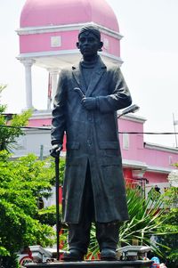 Man standing against built structure