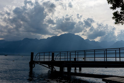 Pier over lake against sky